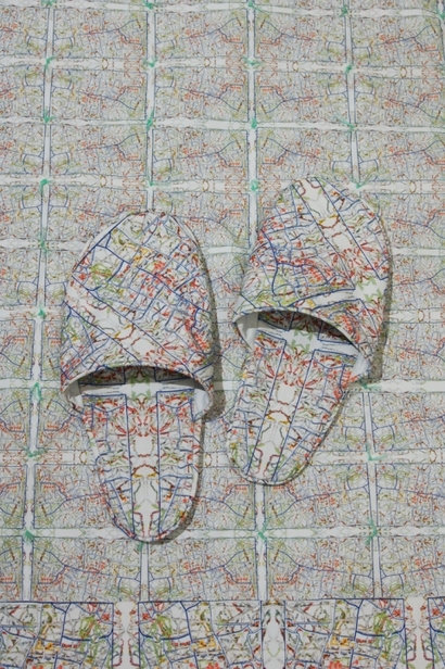 278,000 Miles/Map Installation, detail of rug with slippers, 2011